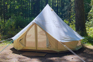 canvas bell tent in wooded campground