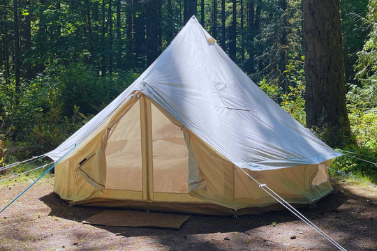 canvas bell tent in wooded campground