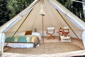 glamping furniture inside white camping tent