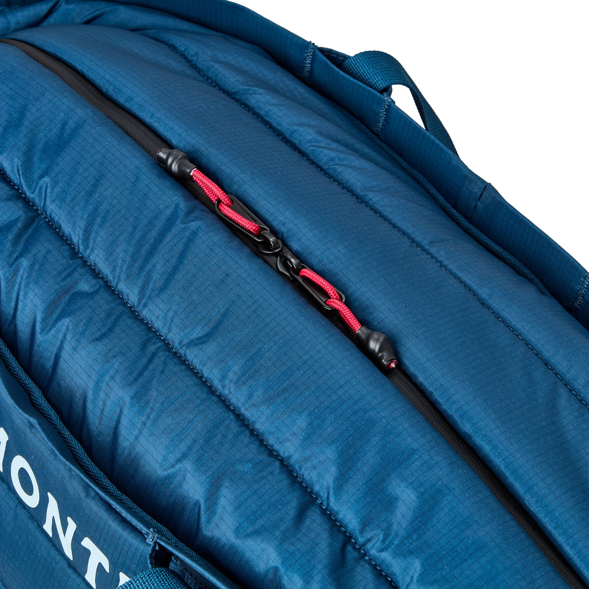 Close-up of a blue cooler bag with a black zipper and red pull tab on a white background.