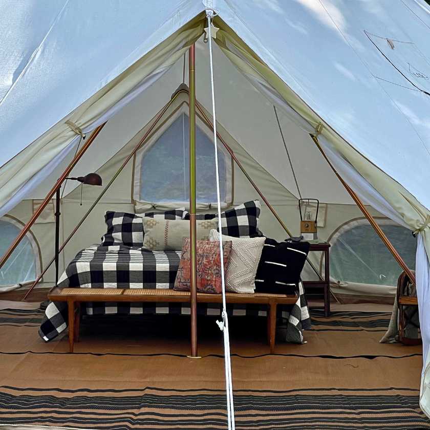 zephyr camping tent with real bed and lanterns in it