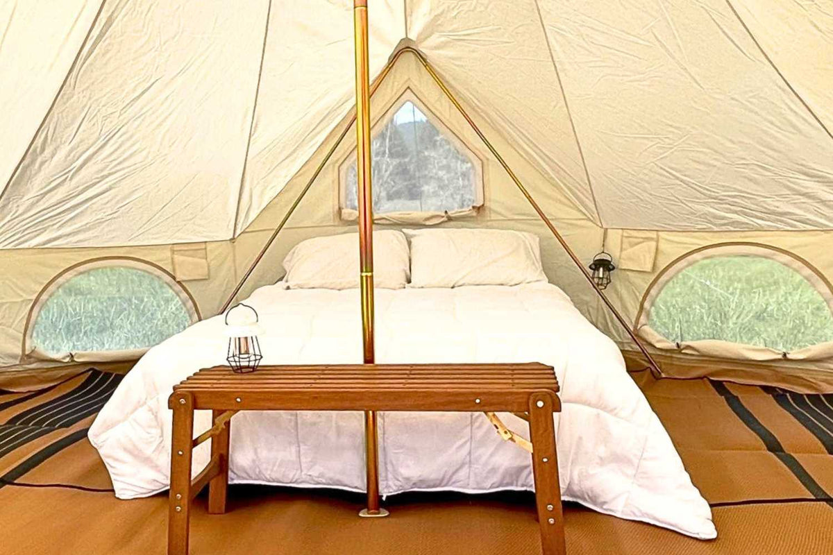 queen bed inside bell tent