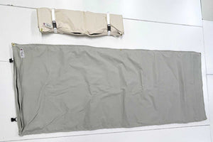 gray and white canvas bedrolls on table