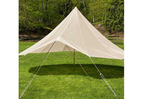 bell tent fly set up on grass with trees in the background
