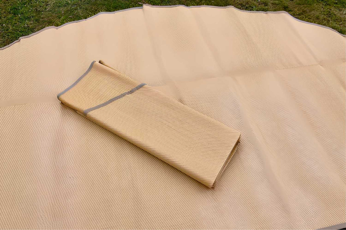 close up of poly rug folded on grass