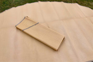 close up of poly rug folded on grass