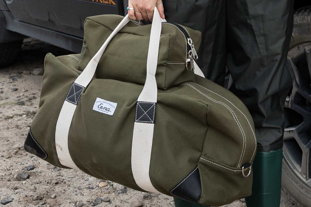canvas duffel bag being held in hand