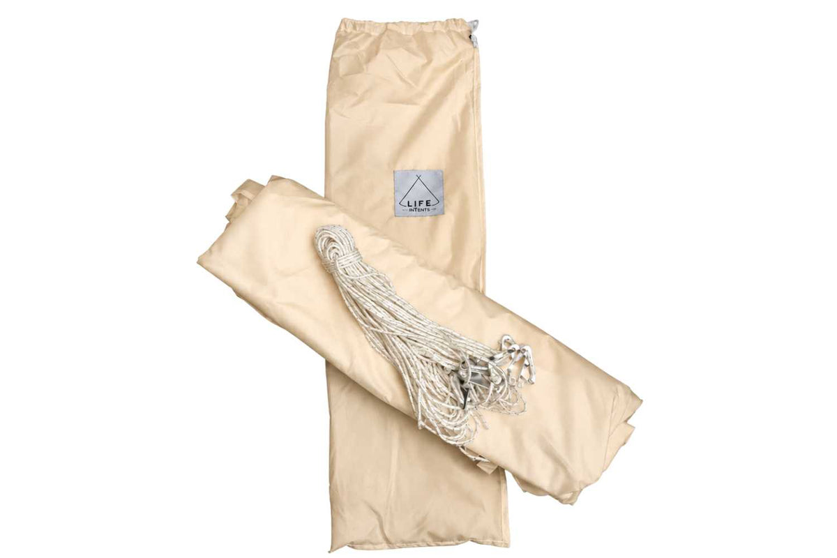 Beige bell tent bag with ropes and a bard label on a white background