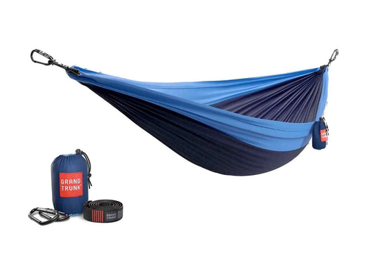 Blue and navy hammock with carrying bag and straps on a white background