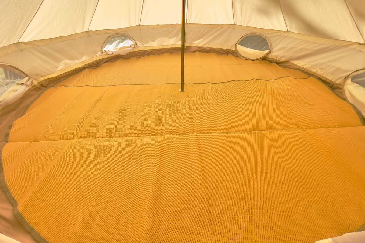 tan rug inside bell tent