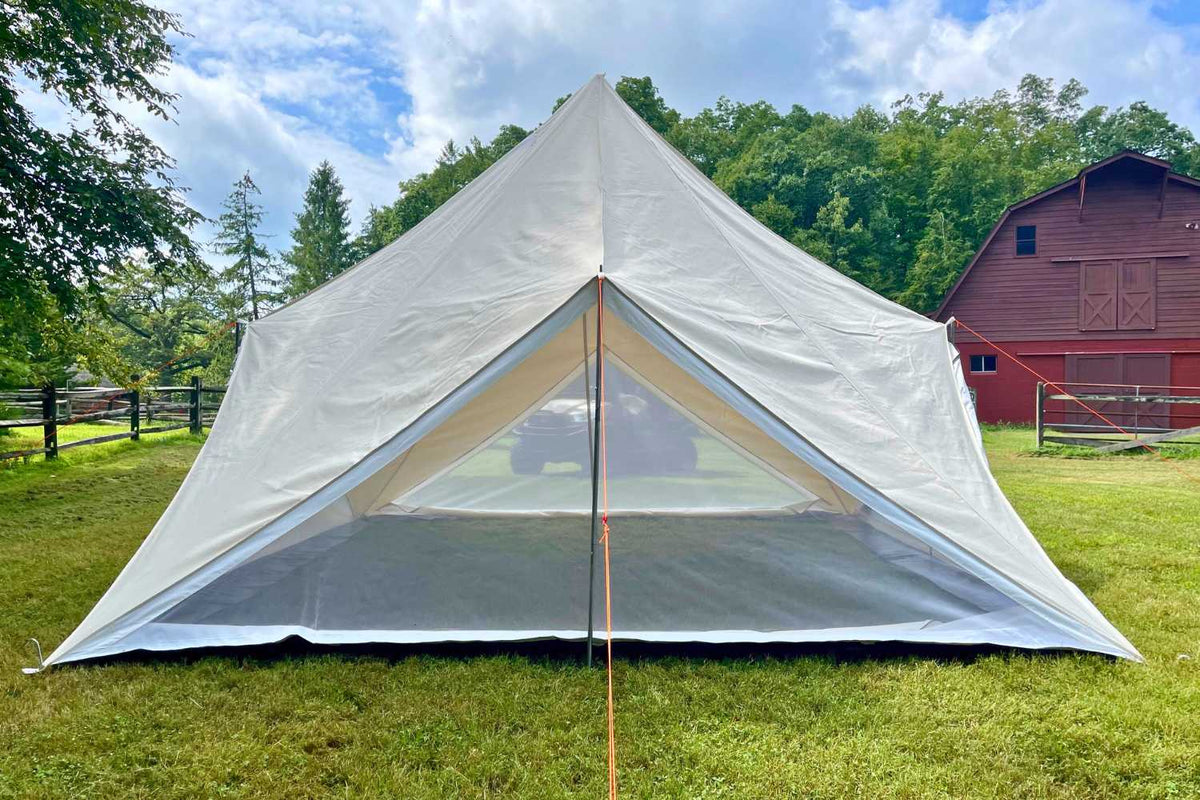 canvas tent in front of barn