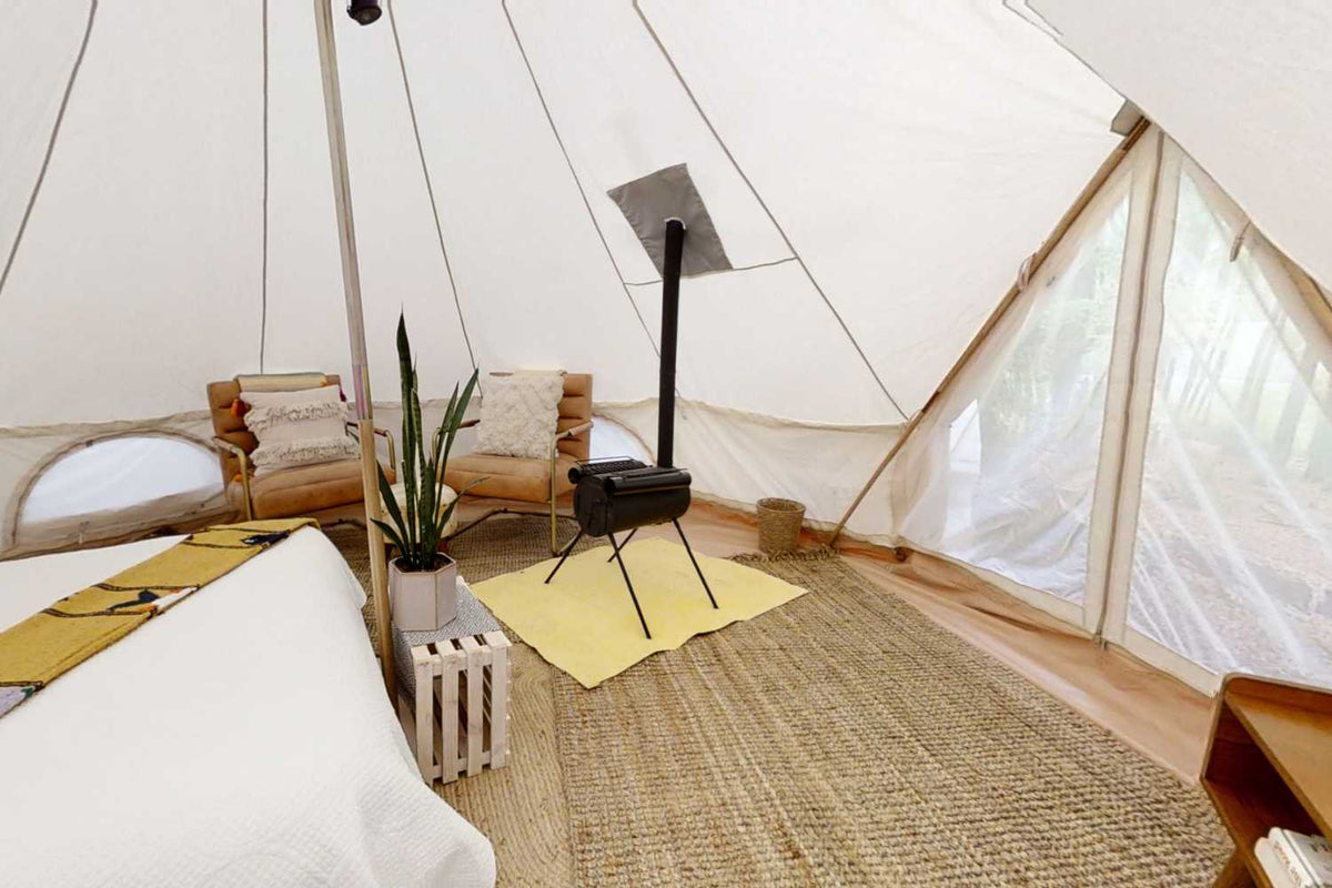 wood stove inside of a canvas tent