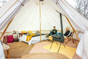 bell tent with stove and people