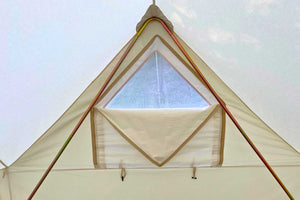 canvas bell tent with window above bed