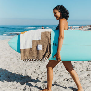 horizon blanket with surfboard and woman