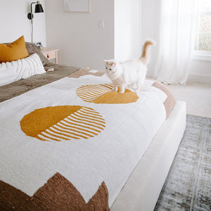 horizon blanket with cat on bed