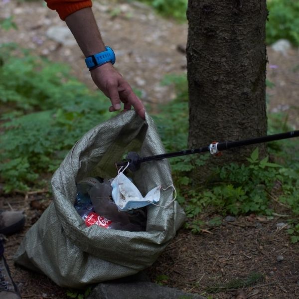 pack out bag filled with trash in woods