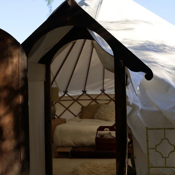 canvas yurt tent with wooden doorframe 