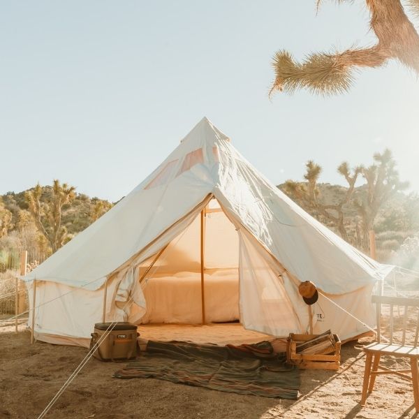 white canvas bell tent set up in the desert