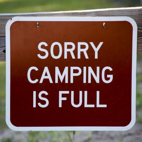 brown and white camping is full sign