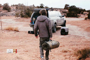 man in dessert by truck