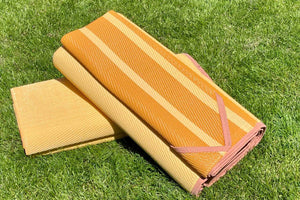 2 folded yellow stripped waterproof mats