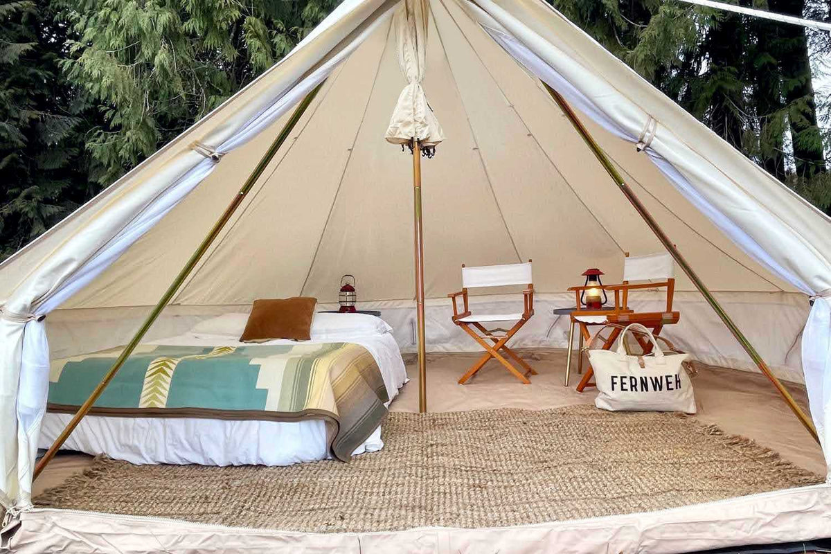 glamping furniture inside white camping tent