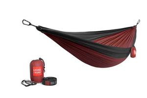 Red and black hammock with carrying bag and straps on a white background