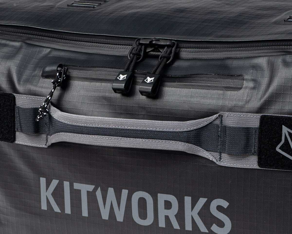 Gray bag with 'KITWORKS' branding and black zippers