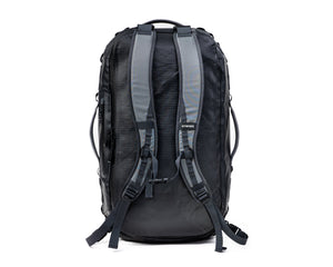 A black and gray technical backpack shown from the back, featuring padded shoulder straps and compression buckles, on a solid white background.
