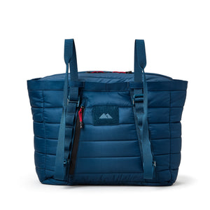 Blue quilted cooler with straps on a white background