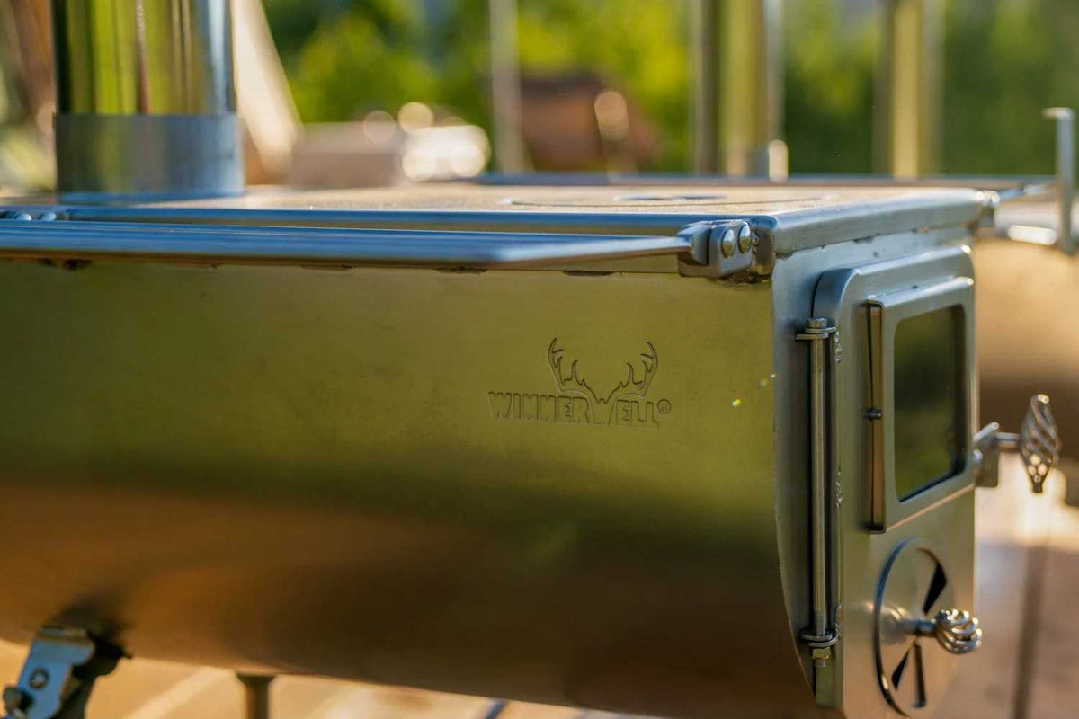 stainless steel tent stove view with winnerwell logo