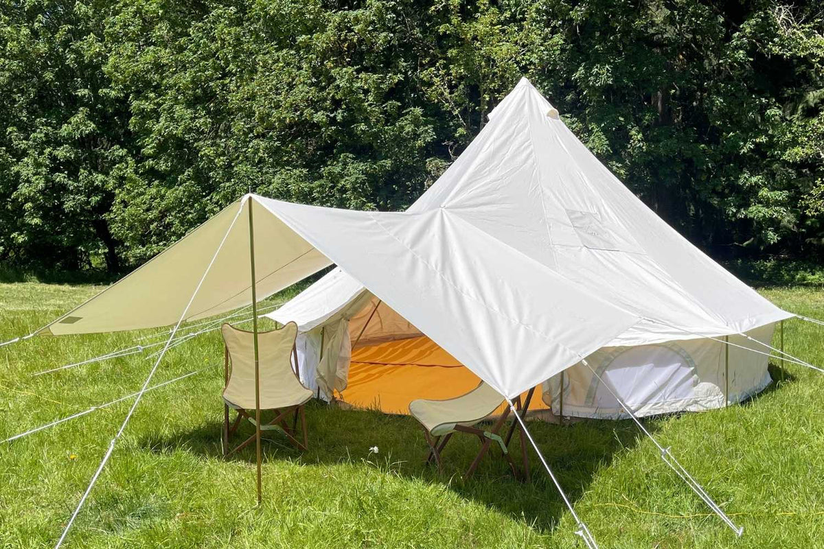 canvas bell tent with canvas awning and chairs