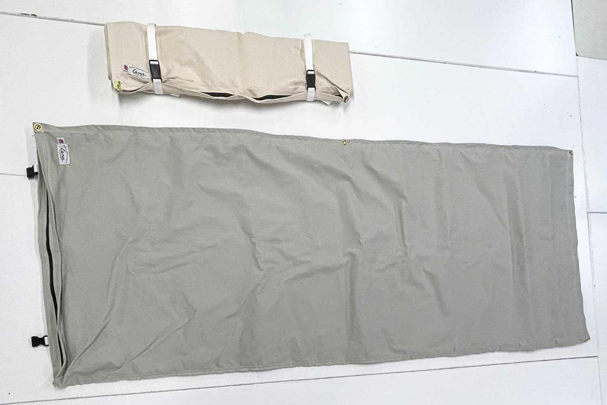 gray and white canvas bedrolls on table