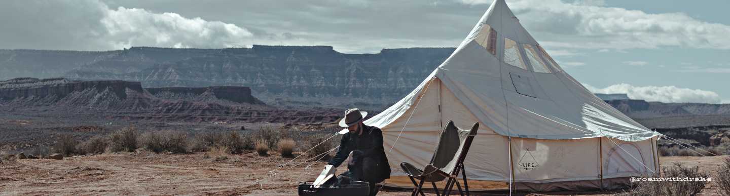 man camping with canvas tent