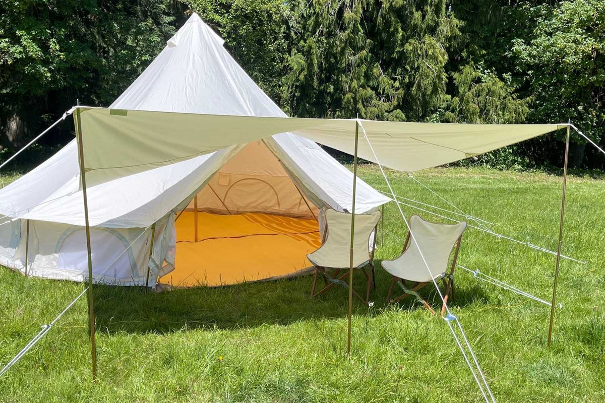 2 chairs in front of a bell tent