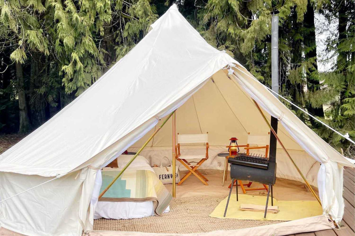 canvas tent with stove and bed