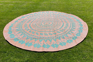 tan side of bell tent rug with blue designs