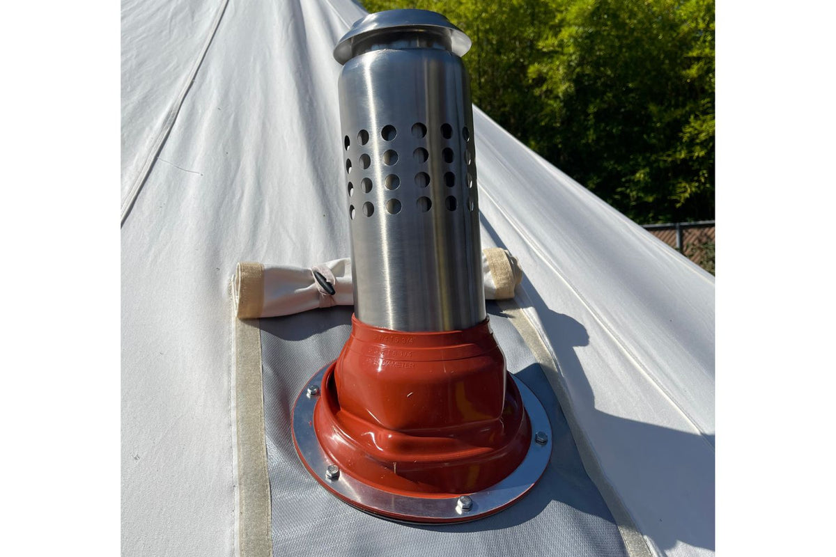 A stainless steel chimney pipe with a flashing kit installed on canvas tent