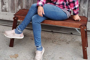 woman sitting on foldable wood bench