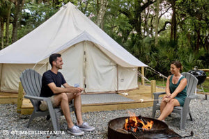 canvas glamping tent with people by fire
