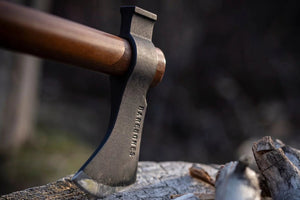 field hatchet stuck in a log