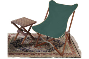 green glamping chair with table and rug