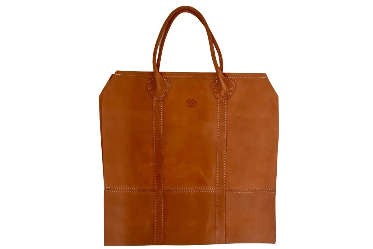 suede firewood carrier on white background