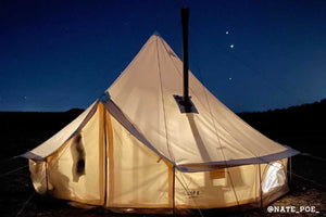 canvas tent with stove wood stove at night