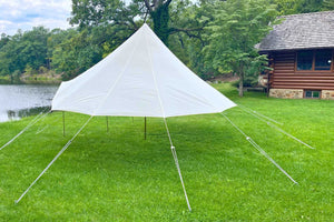large round pop up shelter tent near log cabin