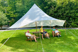 yard shade tent with family sitting under it