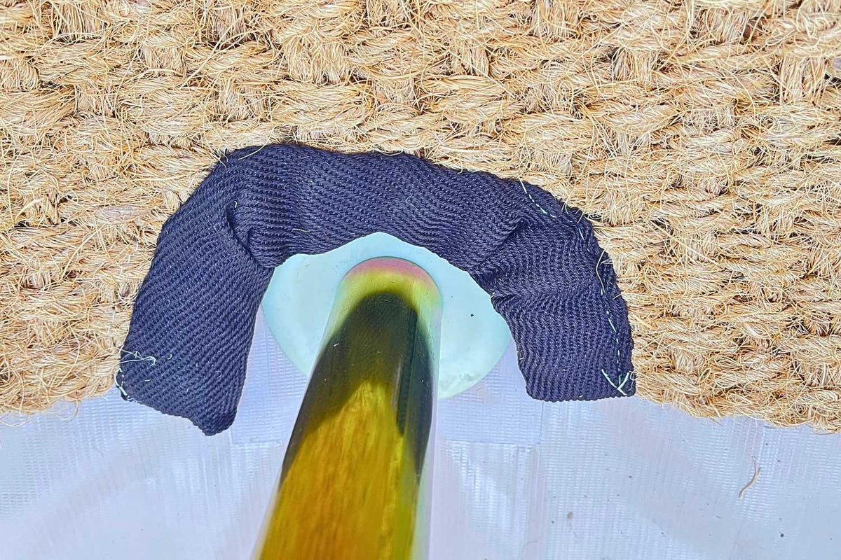 pole on floor of bell tent with a rug by it