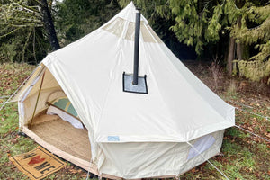 stove pipe coming out of white bell tent